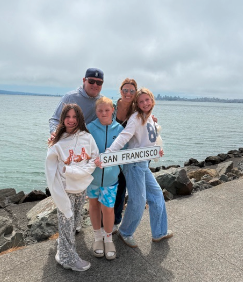 Family photo holding a sign that says San Fransisco