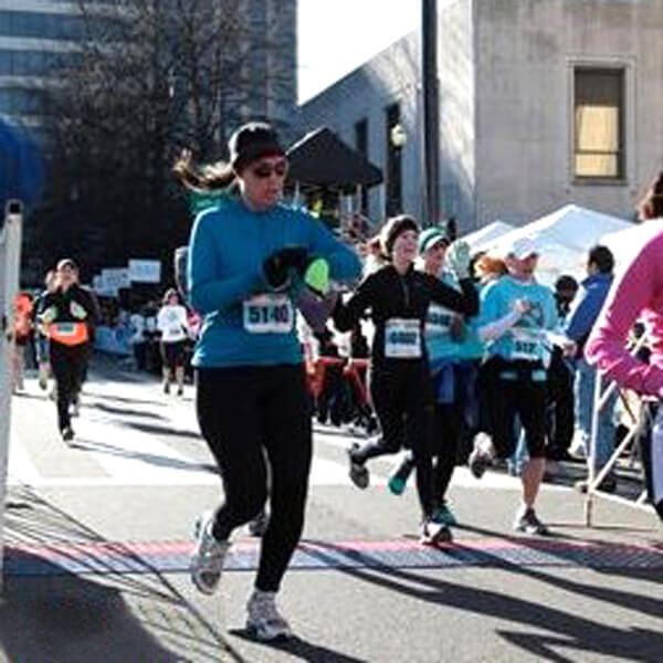 Michelle Calcote King crossing the finish line of a half marathon