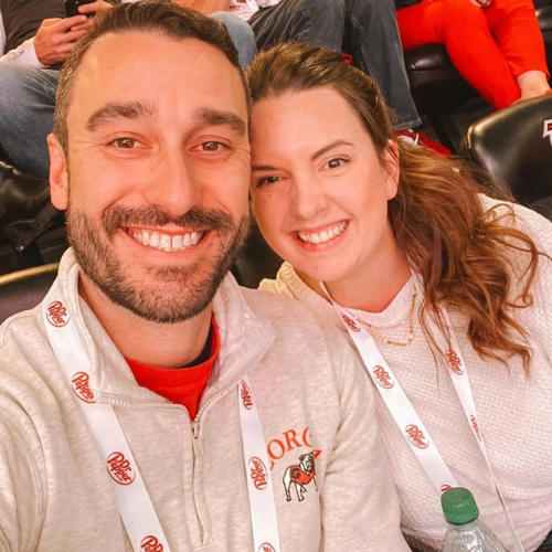 Two smiling faces at a sporting event