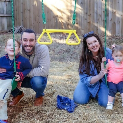 Family picture with Mom and Dad and two kids on swings