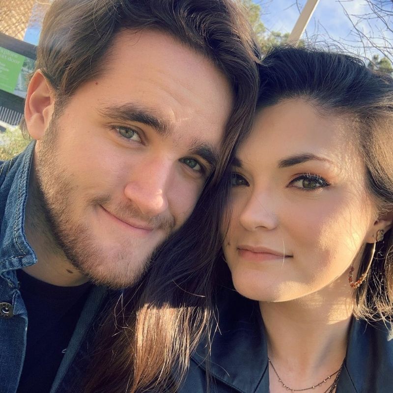 Selfie of a couple outdoors smiling.