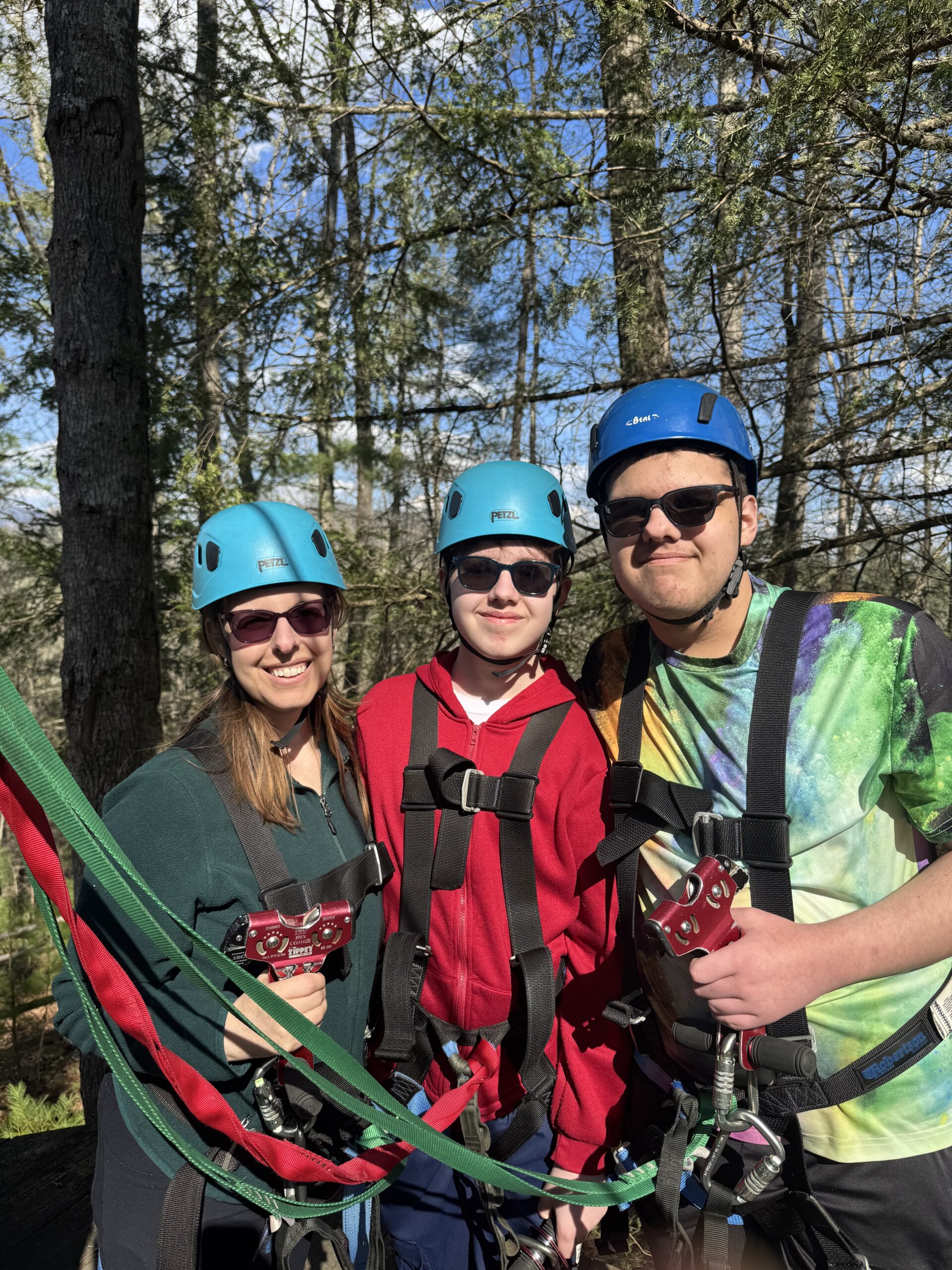 Kathryn Bracho and two sons wearing helmets and harnesses