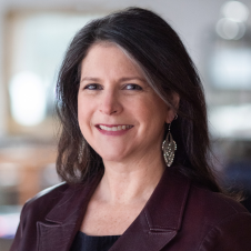 Headshot of Erika Steinberg on a blurred background