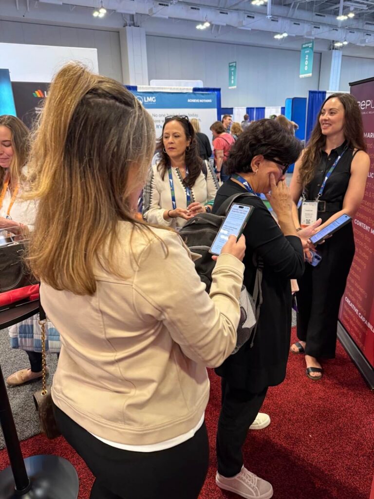 Crowd showing foot traffic at Reputation Ink "INKredibles" superhero themed trade show booth at the ALA conference in 2025