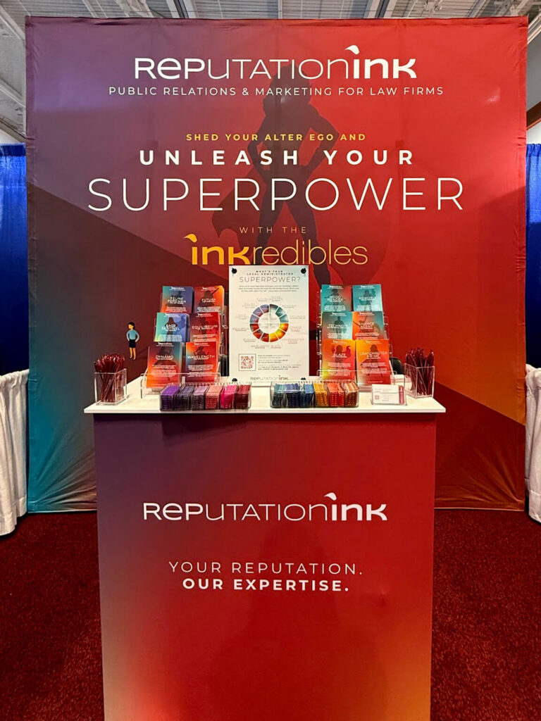 Closeup of tabletop display of Reputation Ink "INKredibles" superhero themed trade show booth at the ALA conference in 2025